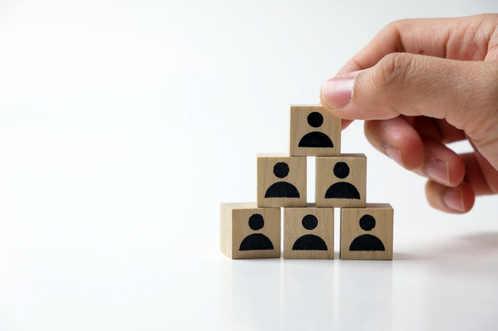 Businessman stacking wooden team blocks
