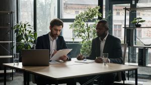 Multiethnic Caucasian and African American business people diverse multiracial men two male partners